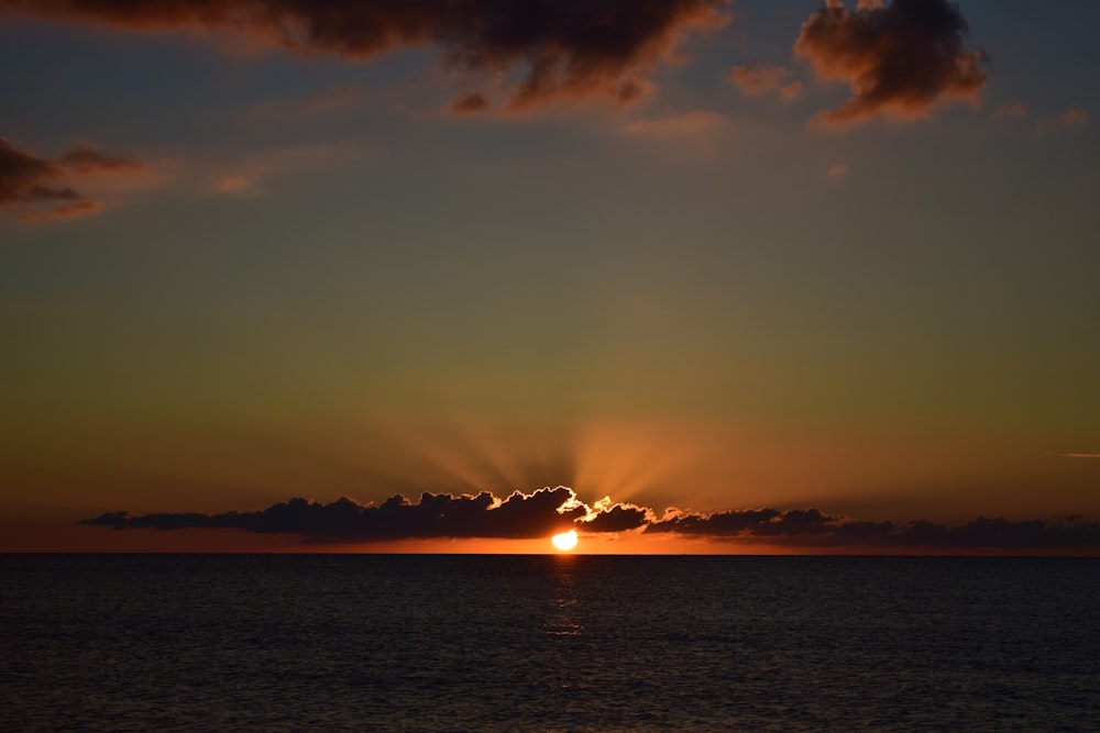 body of water during sunset