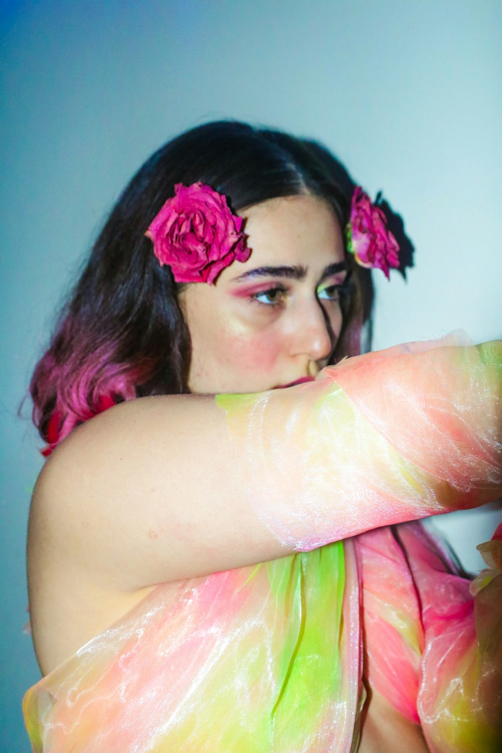 woman with pink and white flower on her ear