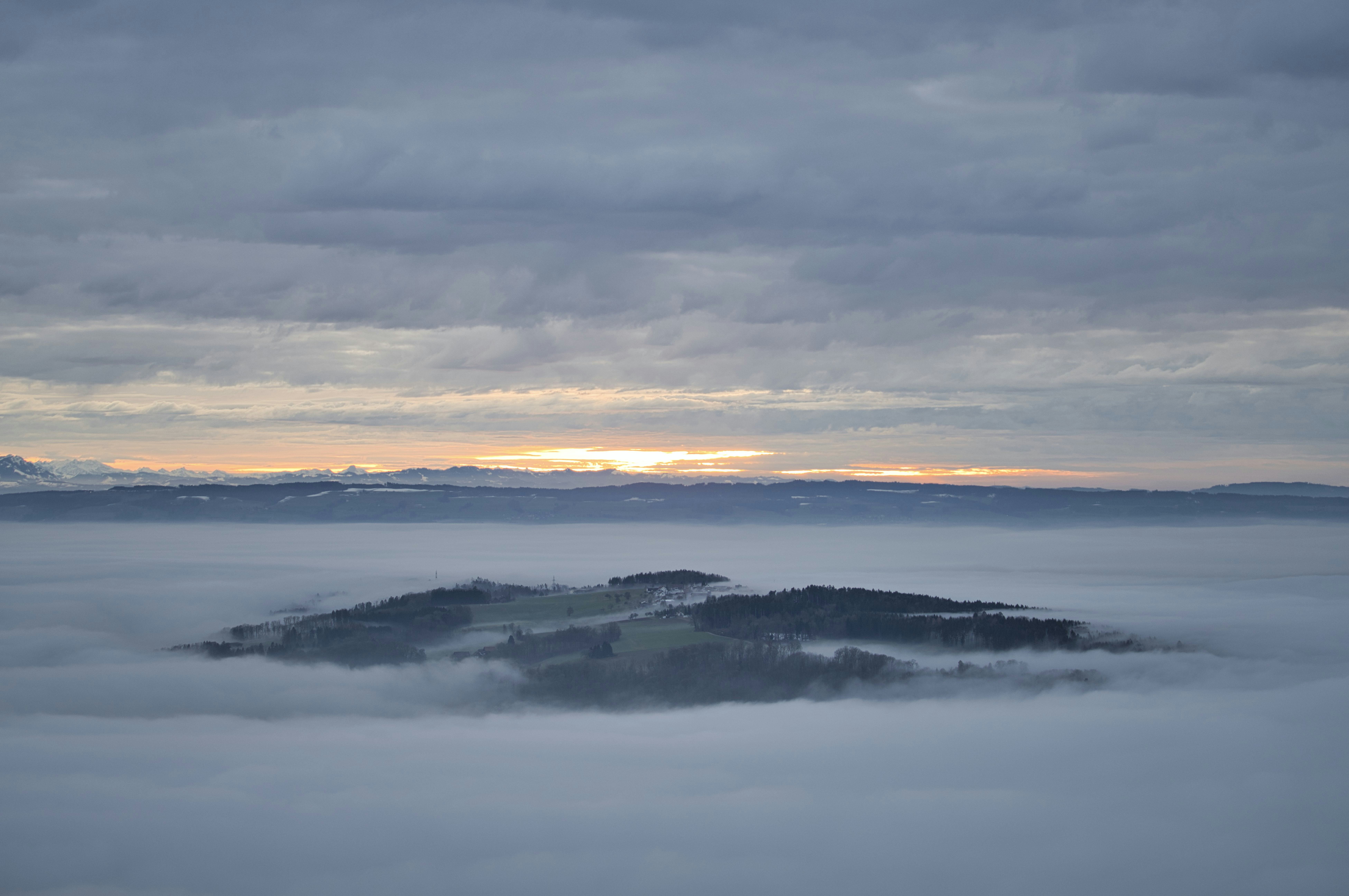 snow covered mountain under cloudy sky during daytime