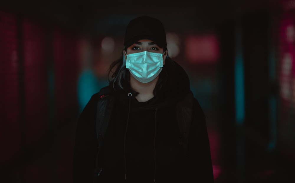 man in black hoodie wearing white mask