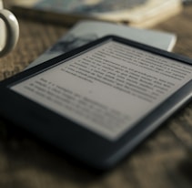 black tablet computer on brown wooden table