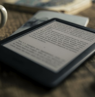 black tablet computer on brown wooden table