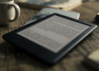 black tablet computer on brown wooden table