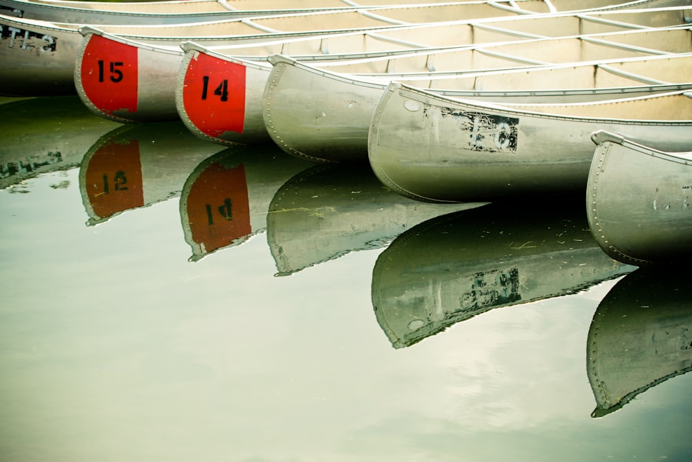 white and orange boats on water