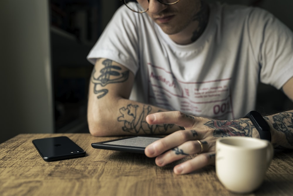 man in white crew neck t-shirt wearing black framed eyeglasses