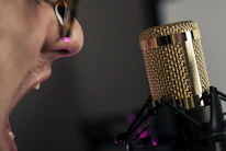 Close-up of a person taking a deep breath before speaking on stage.
