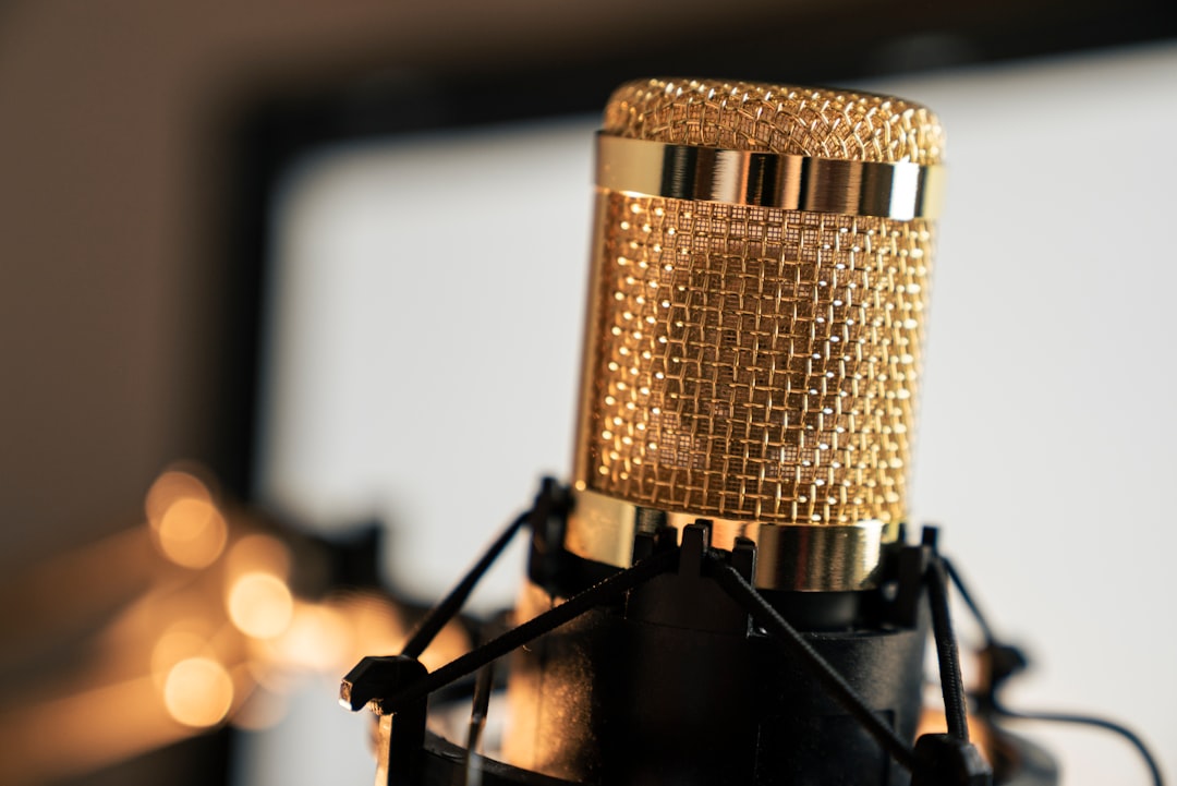 gold condenser microphone on black stand