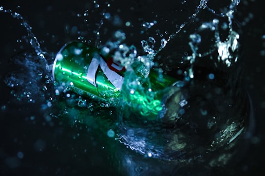 A futuristic cleaning product dissolving in green water.
