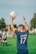 man in blue and white adidas soccer jersey shirt holding white and blue soccer ball