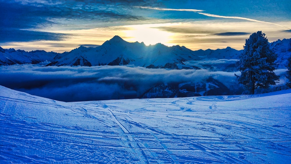 snow covered mountain under cloudy sky during daytime