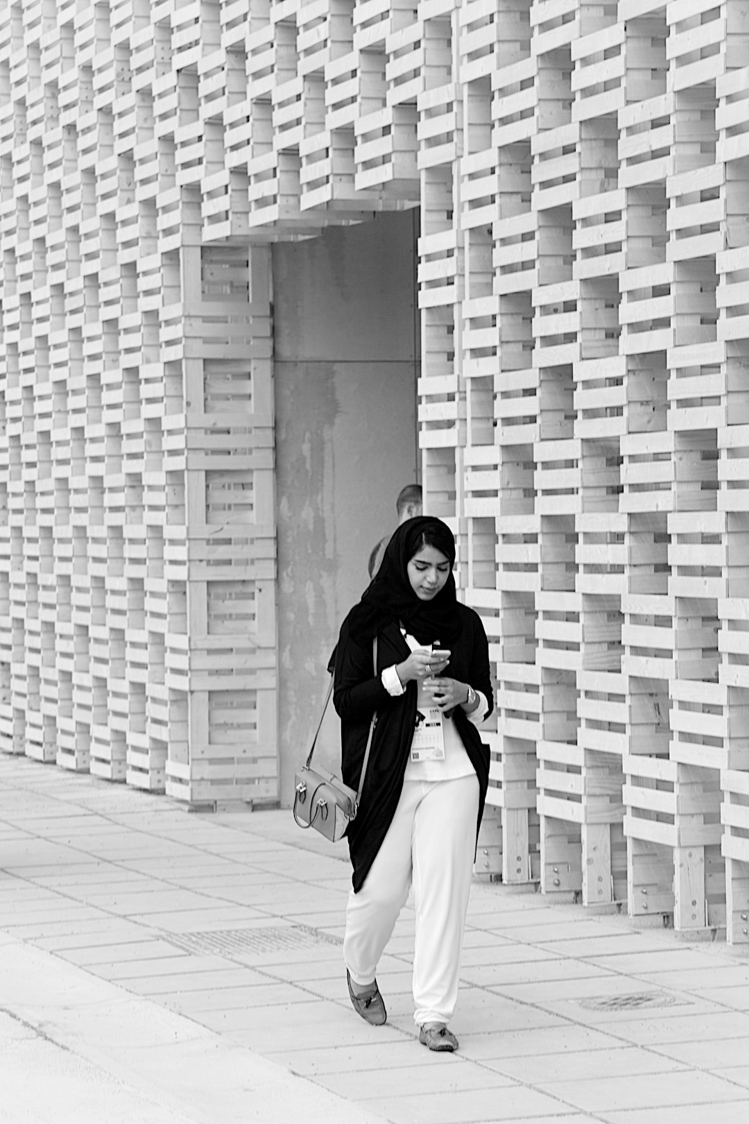 woman in white long sleeve dress standing on gray brick floor