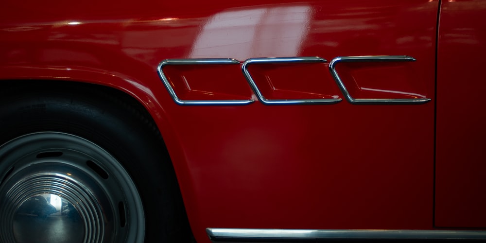 red car with white and black license plate