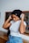 woman in white tank top and black knit cap