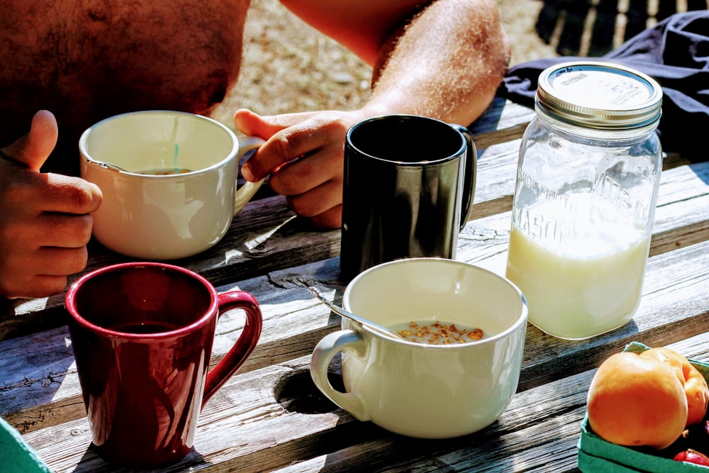 person holding white ceramic mug