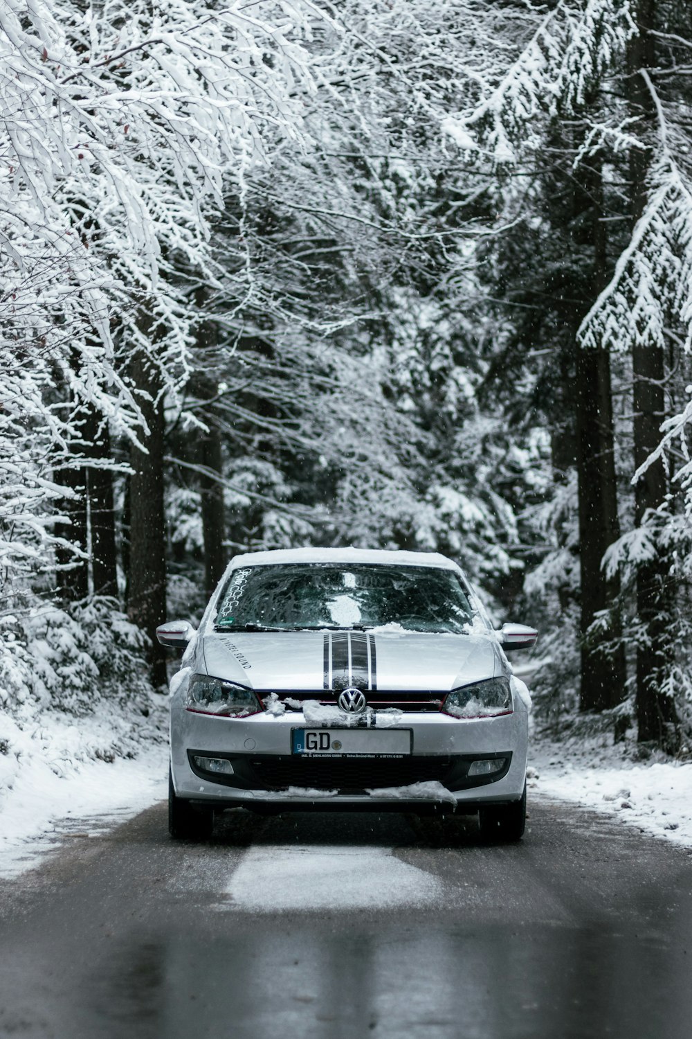 black car on snow covered road