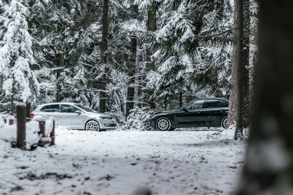 black sedan on snow covered road during daytime