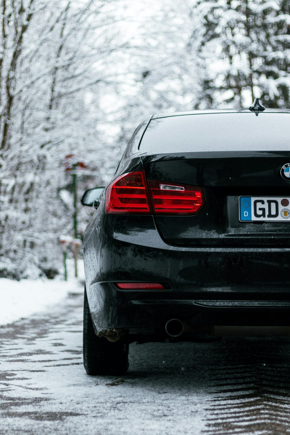 black bmw m 3 on snow covered road during daytime