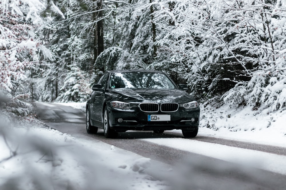black audi a 4 on snow covered road