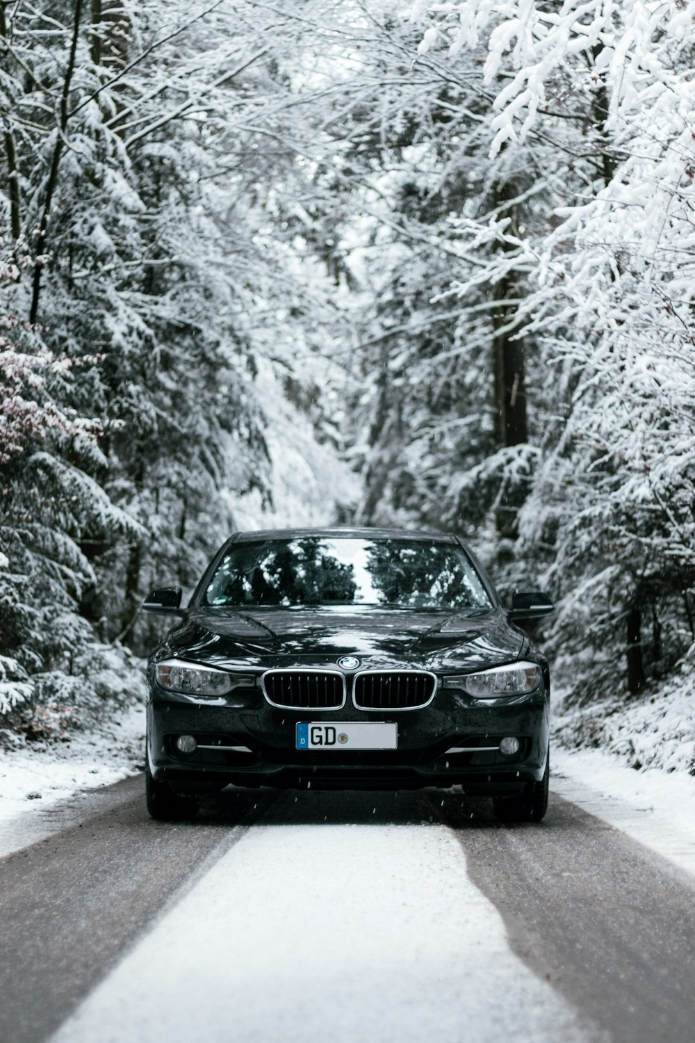 black audi car on snow covered road during daytime