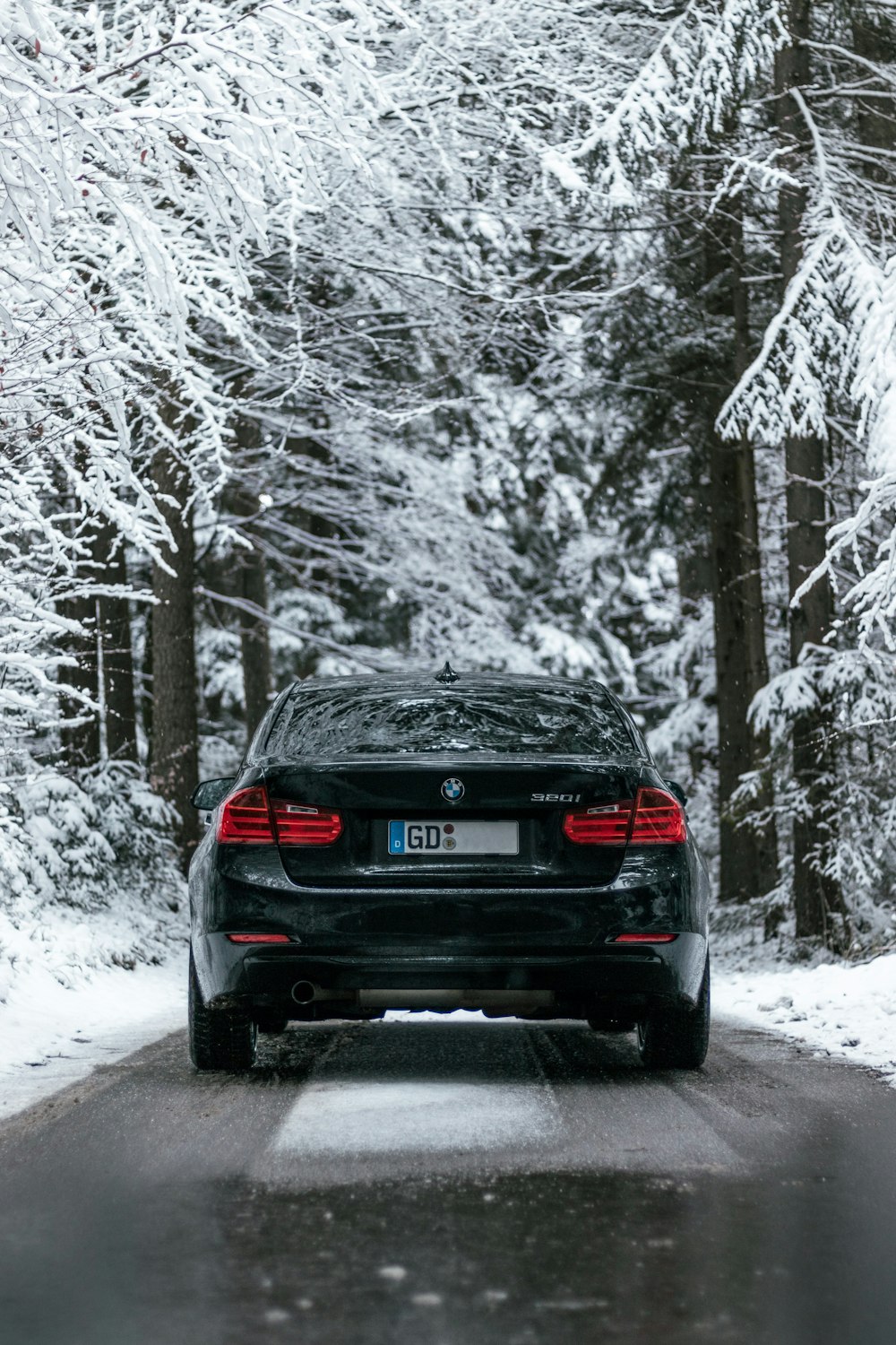 black car on snow covered road