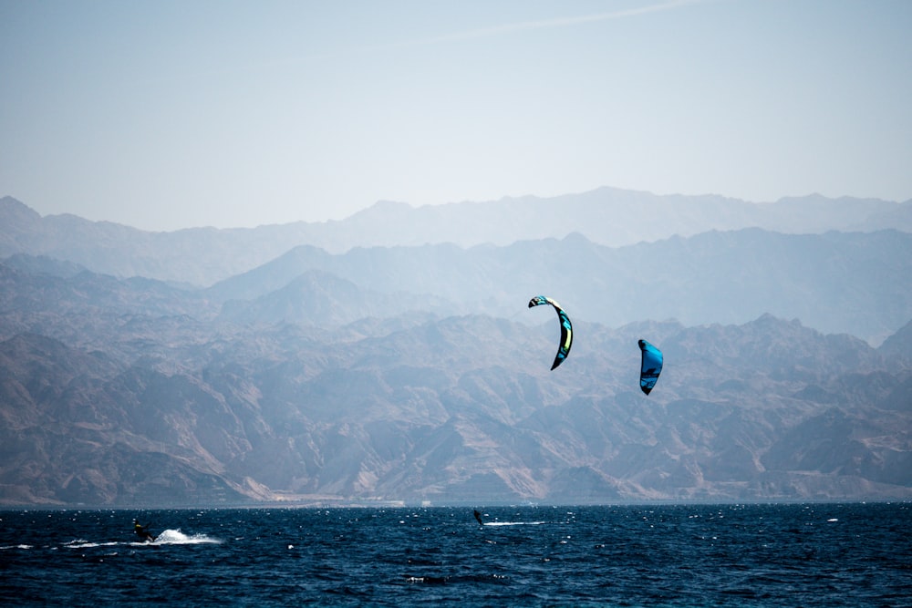 person in blue and white shorts surfing on sea during daytime