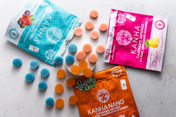 A variety of cannabis gummies in bright packaging displayed in a casual setting.