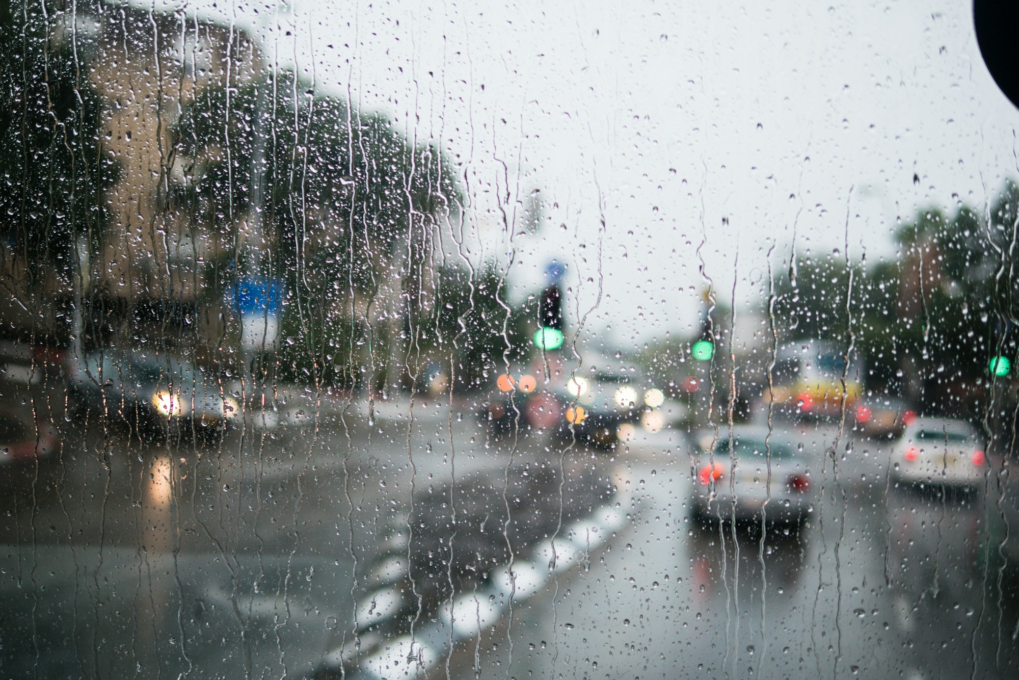 Israel rain view to street through rain-specked window