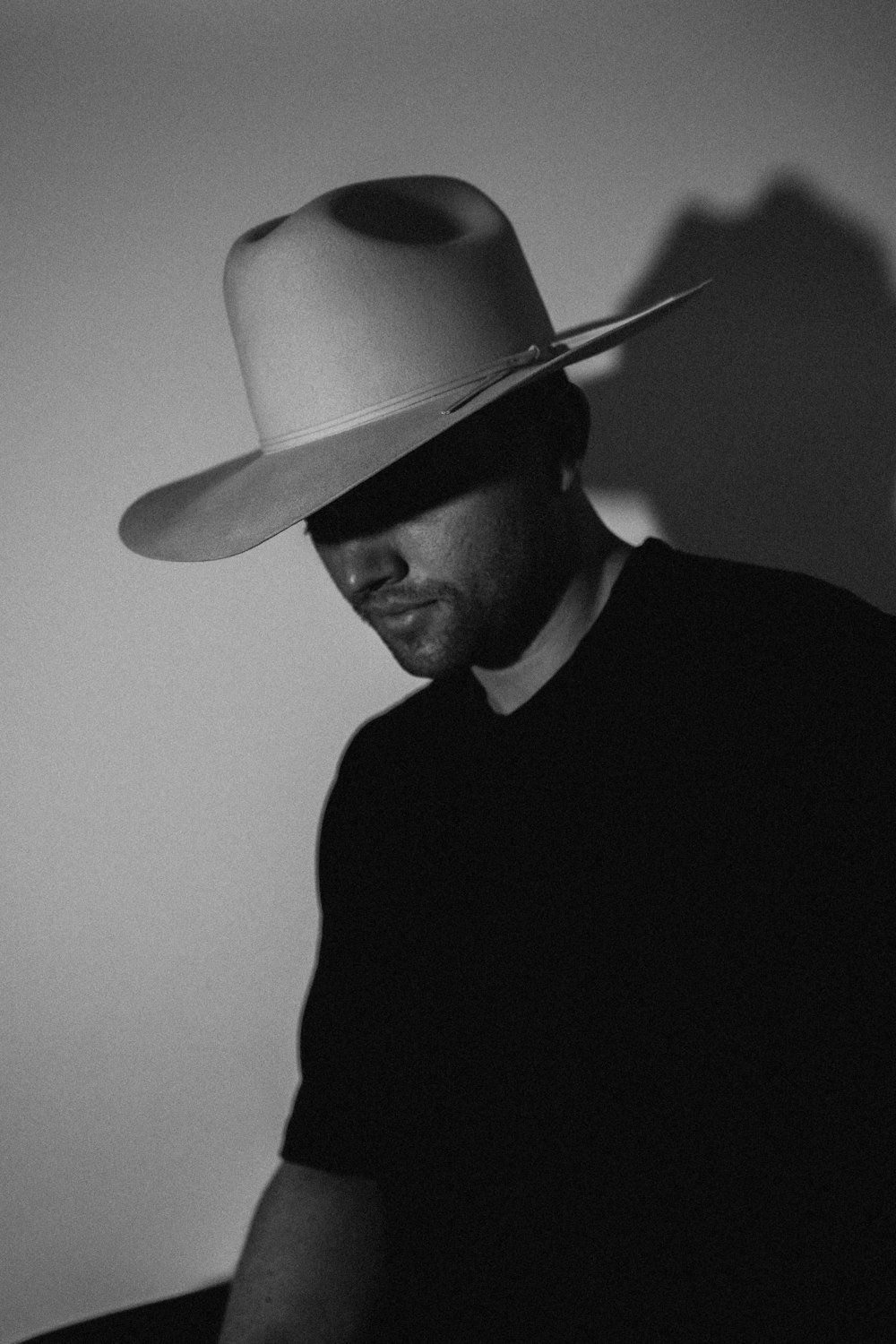 man in black shirt wearing cowboy hat