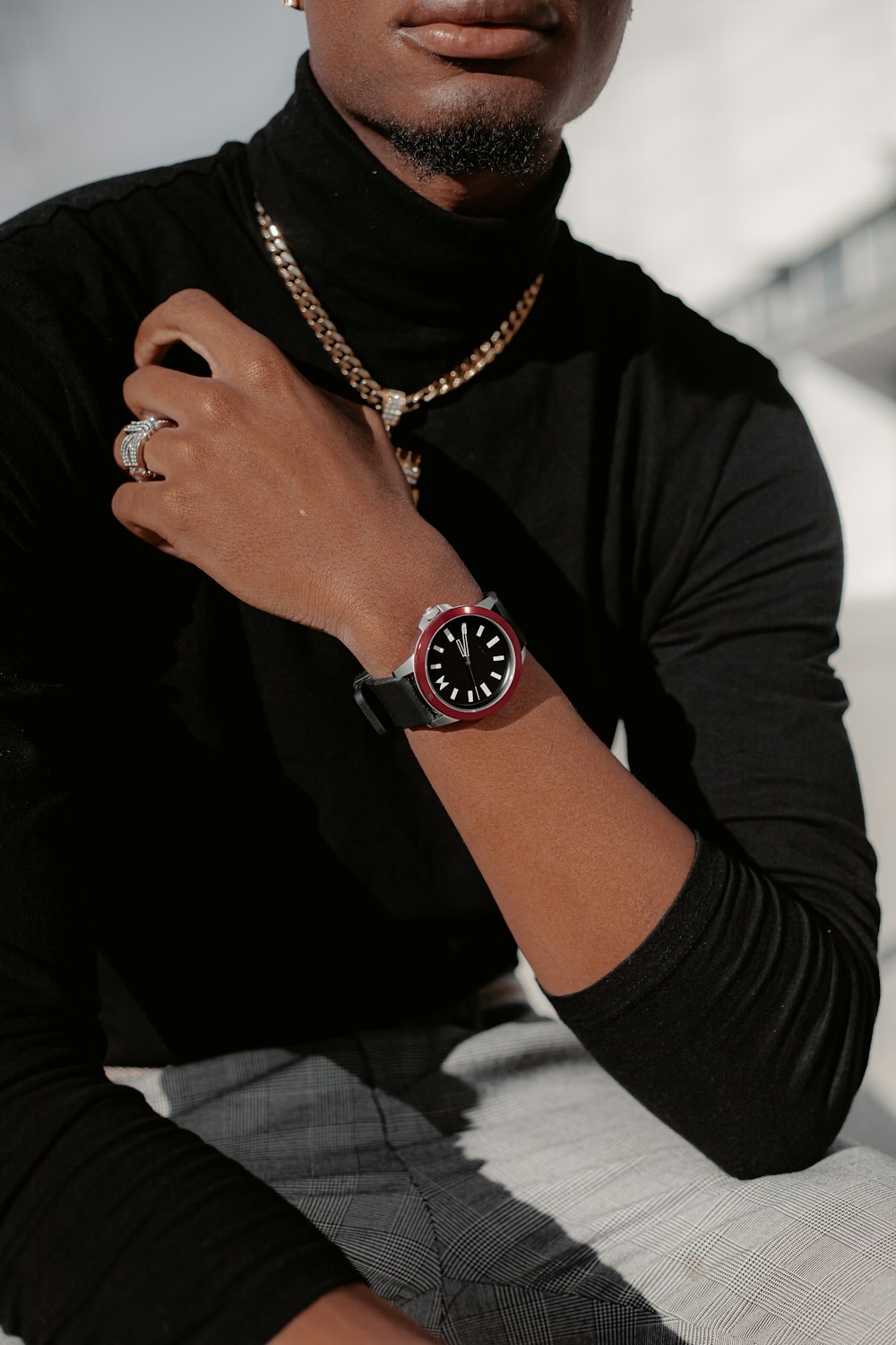 person wearing gold round analog watch