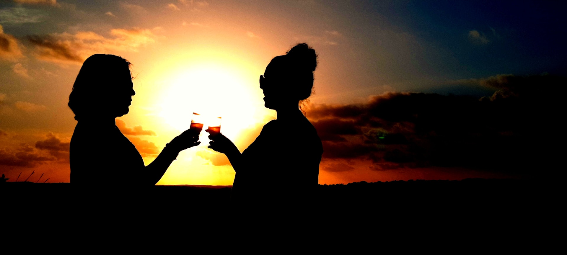 woman wearing yellow long-sleeved dress under white clouds and blue sky during daytime