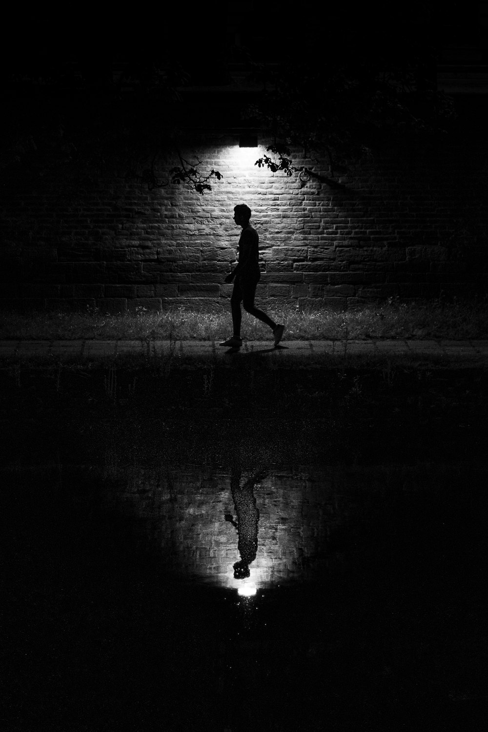 silhouette of man walking on street
