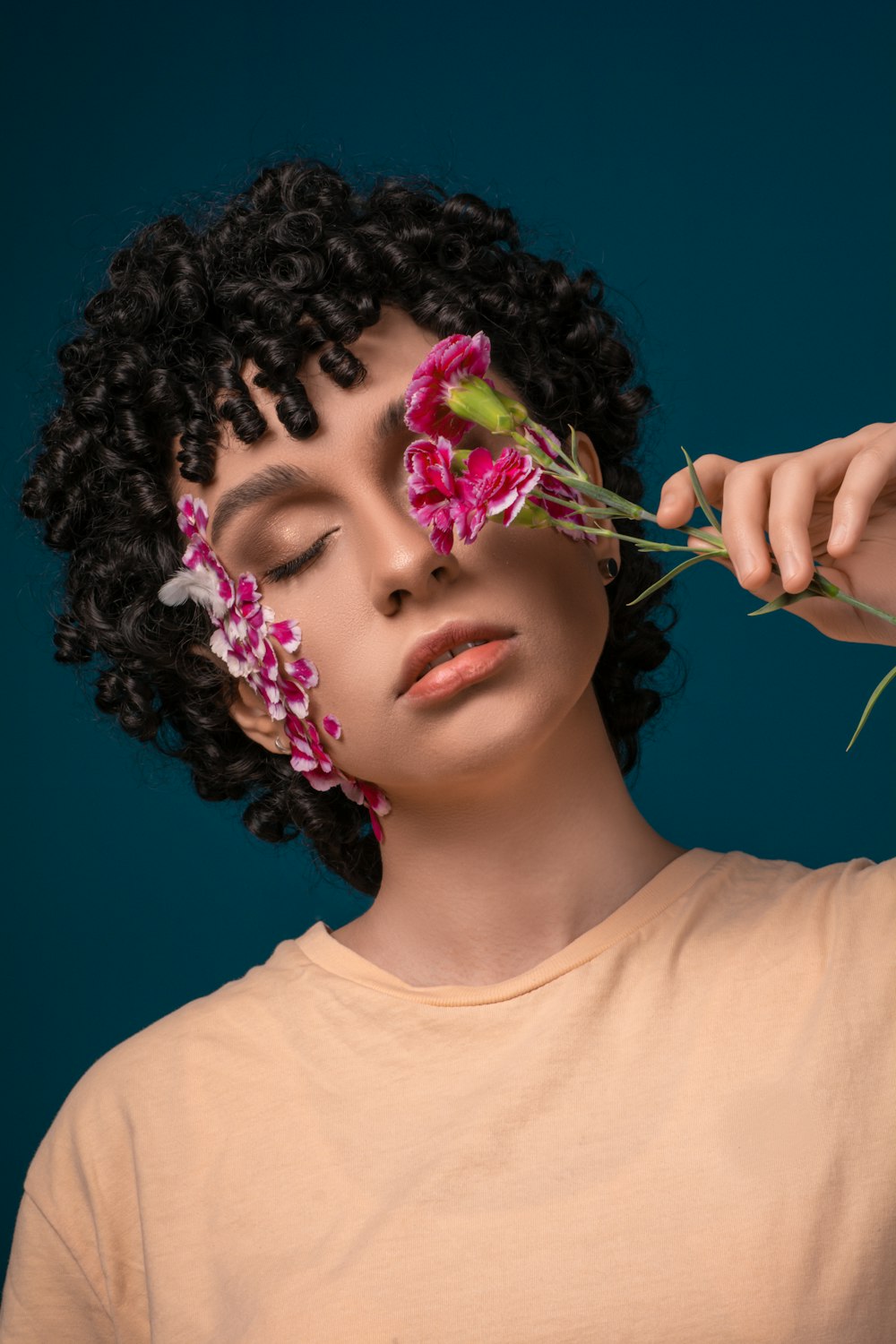 woman in white crew neck shirt with purple and green flower on her ear