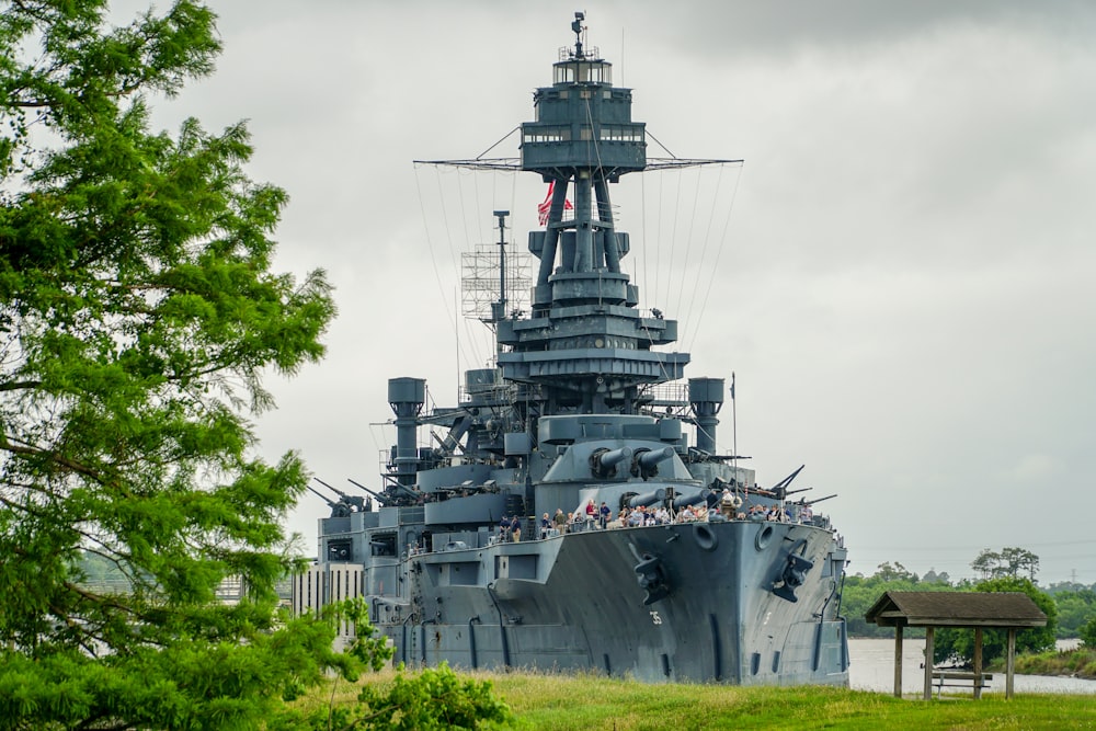 gray and black ship on sea under white clouds during daytime