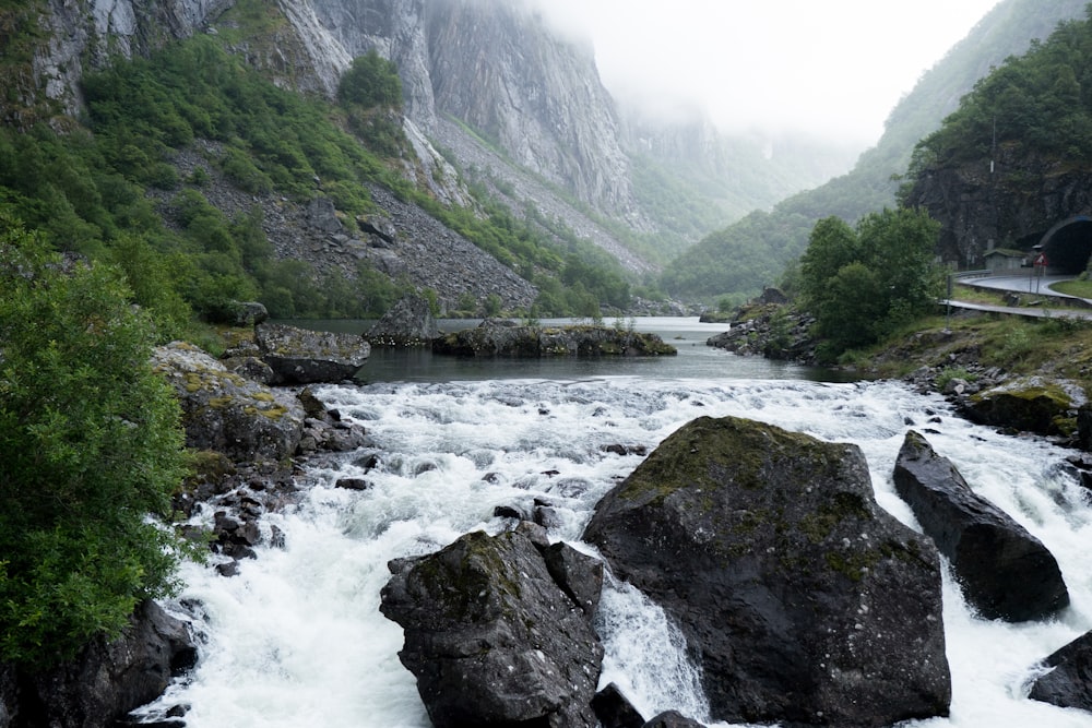 river between green mountains during daytime