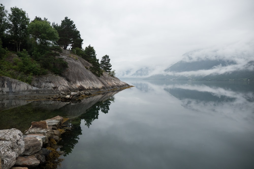 brown rock formation on lake during daytime