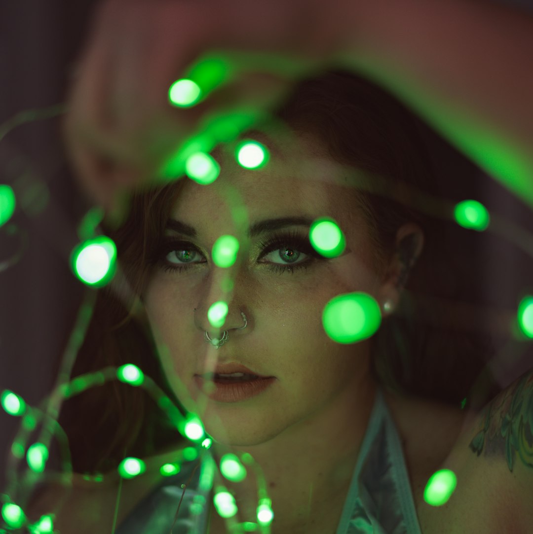 woman in white collared shirt with light on her face