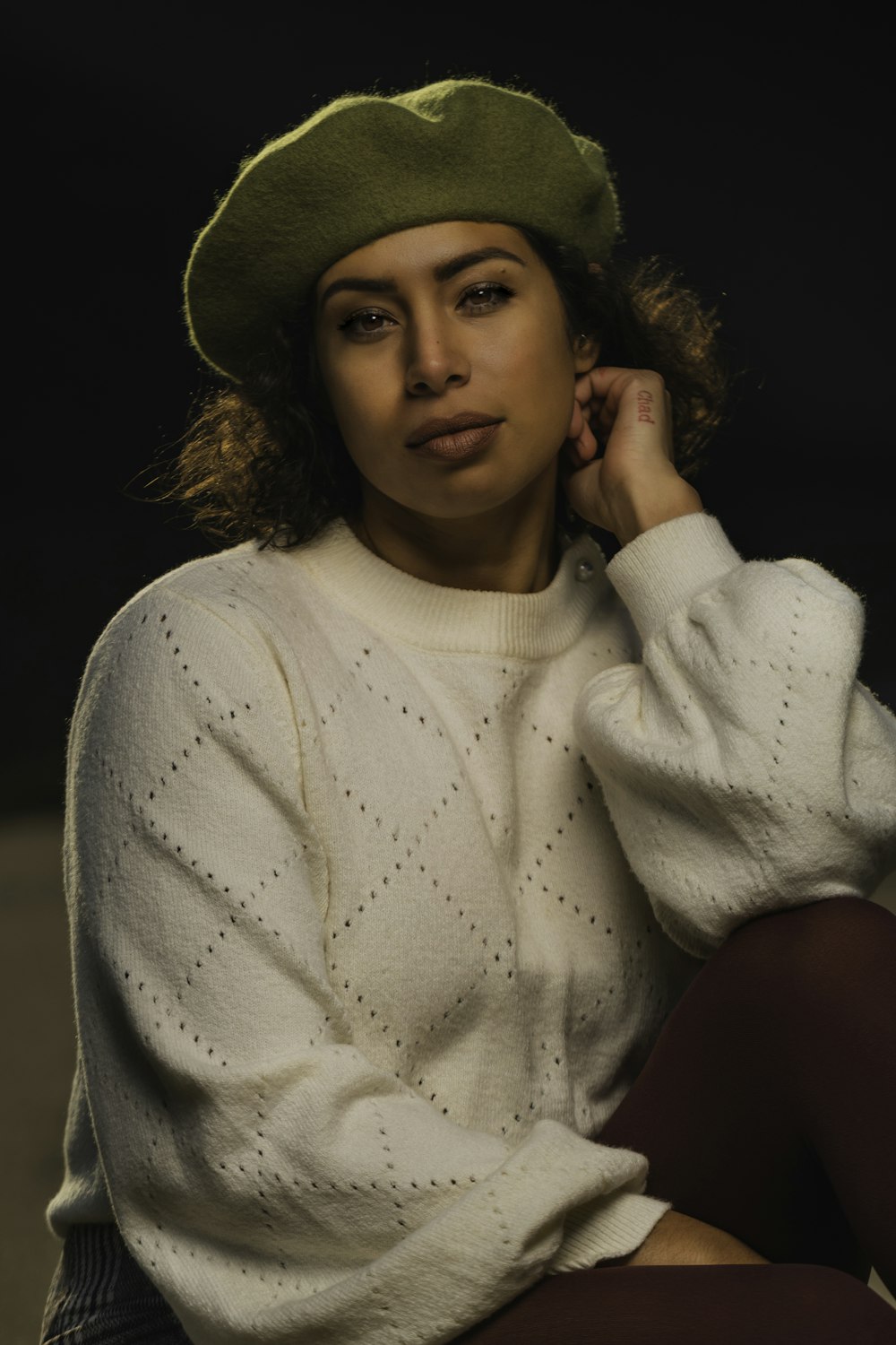woman in white turtleneck sweater wearing brown hat