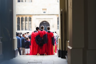 people in red robe walking on street during daytime