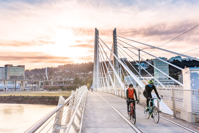 people riding bicycle on bridge during daytime