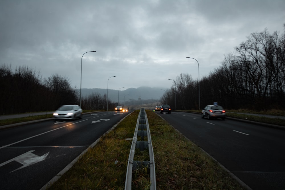 cars on road under cloudy sky during daytime