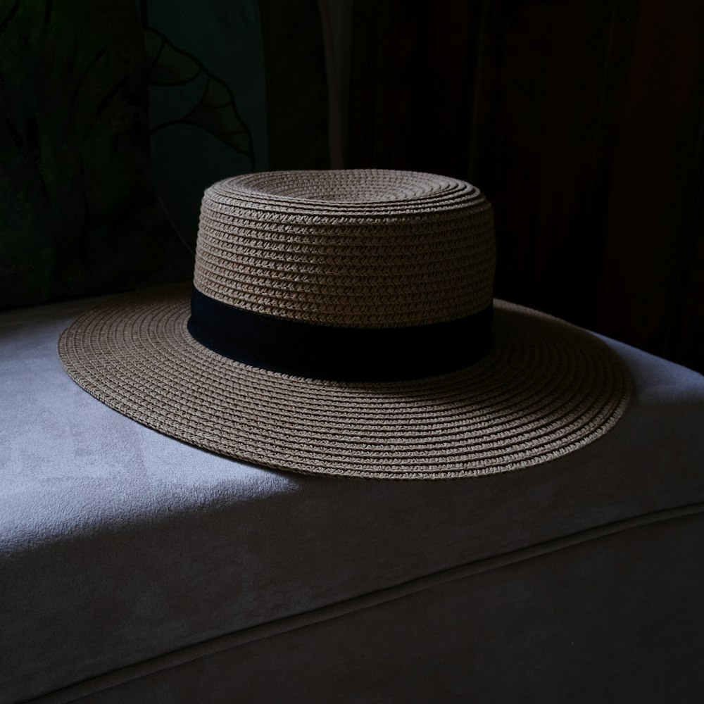 black and white fedora hat on gray textile