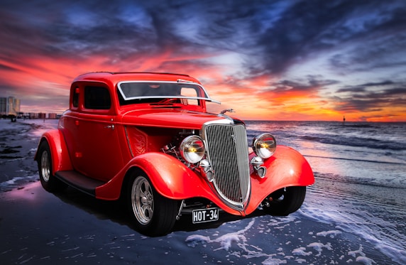 red classic car on road