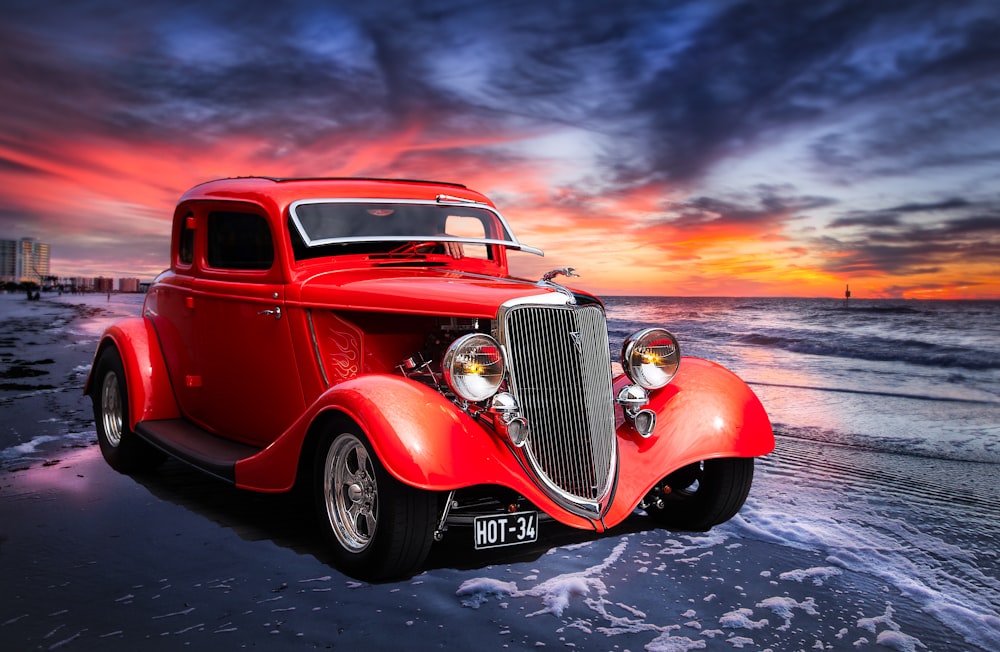 red classic car on road