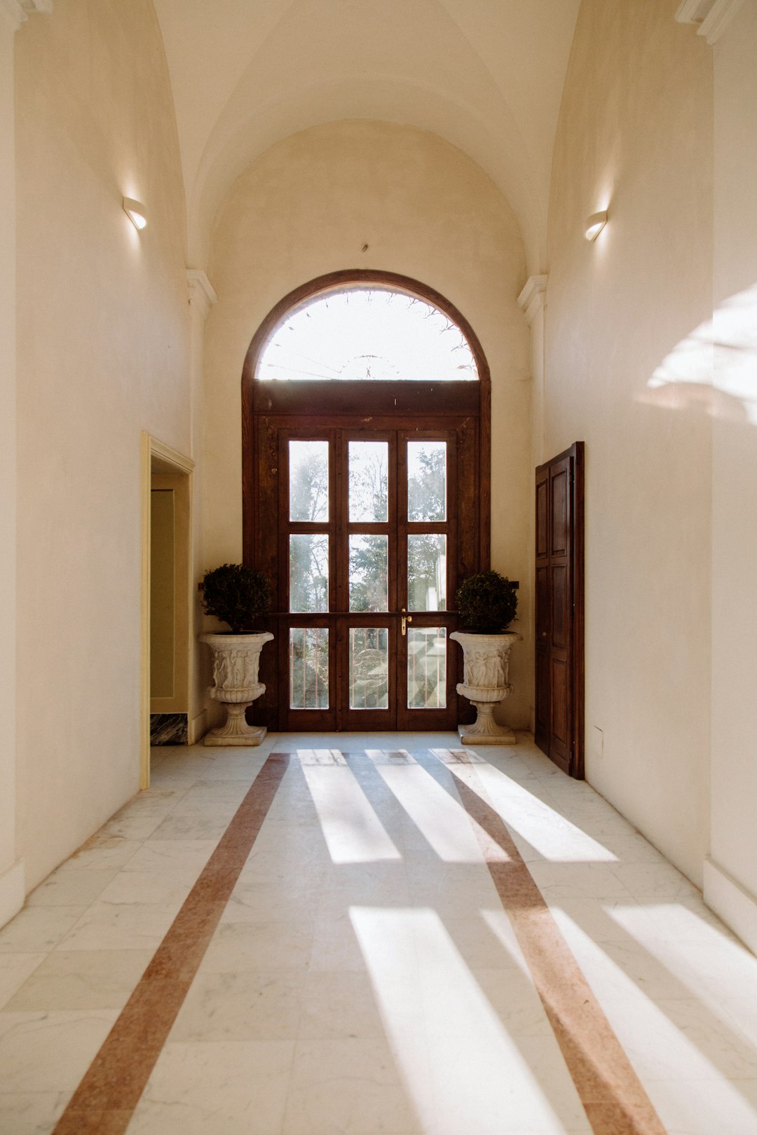 brown wooden door on white painted wall