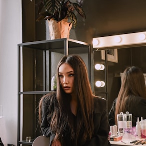 woman in brown leather jacket sitting on chair