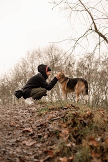 A proud owner gently holding their alert, strong-looking German Shepherd puppy close.
