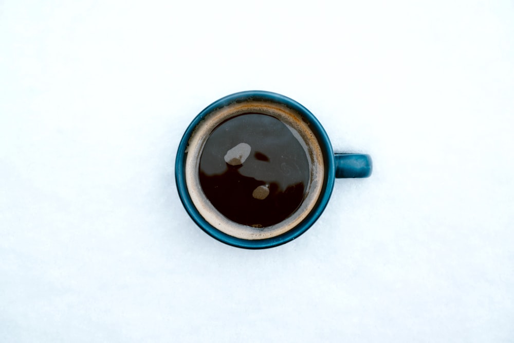 blue ceramic mug with coffee