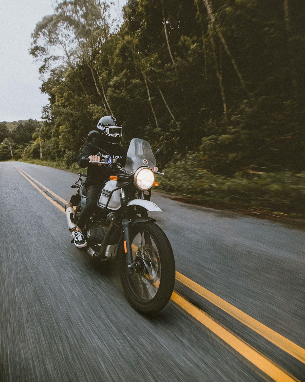 man in black helmet riding motorcycle on road during daytime