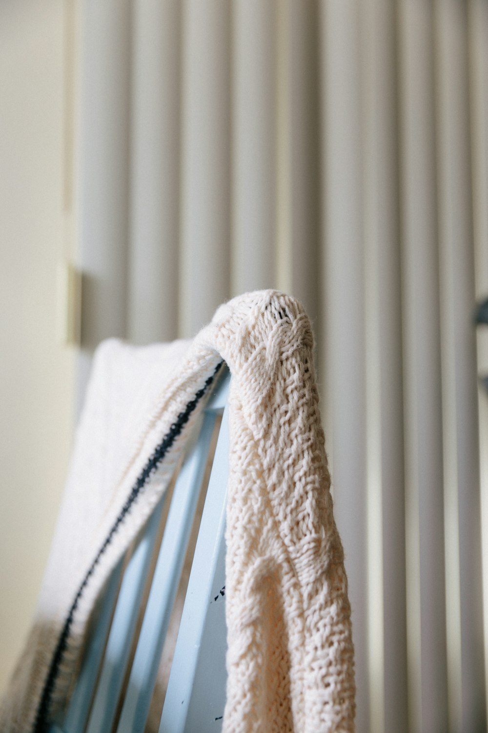 white textile on white window blinds