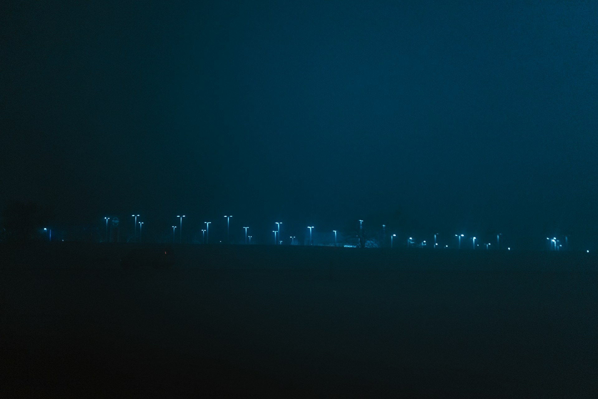 blue and white lights on black wall